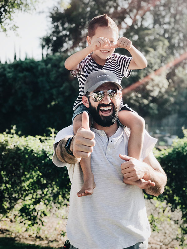 man-holding-a-child--while-smiling